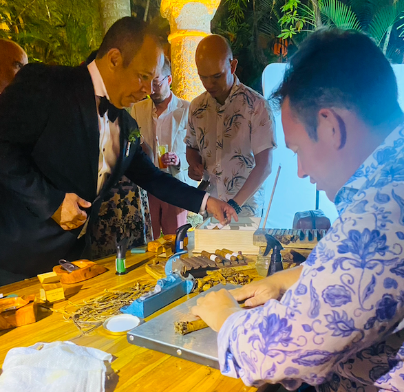 Live cigar hand rolling show at destination wedding celebration Colombia